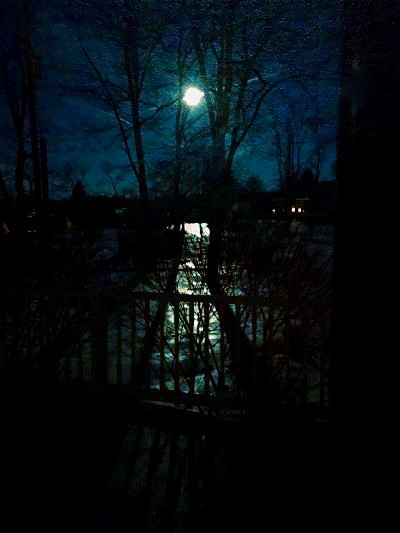 Full Snow Moon casting light over snow